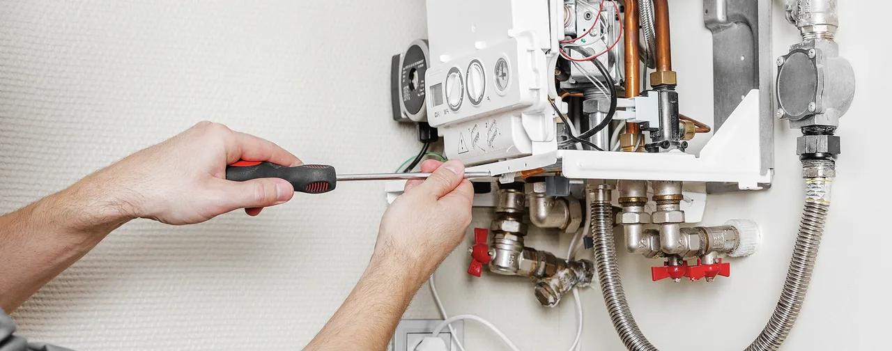 Close-up of a Letsure engineer repairing a gas boiler